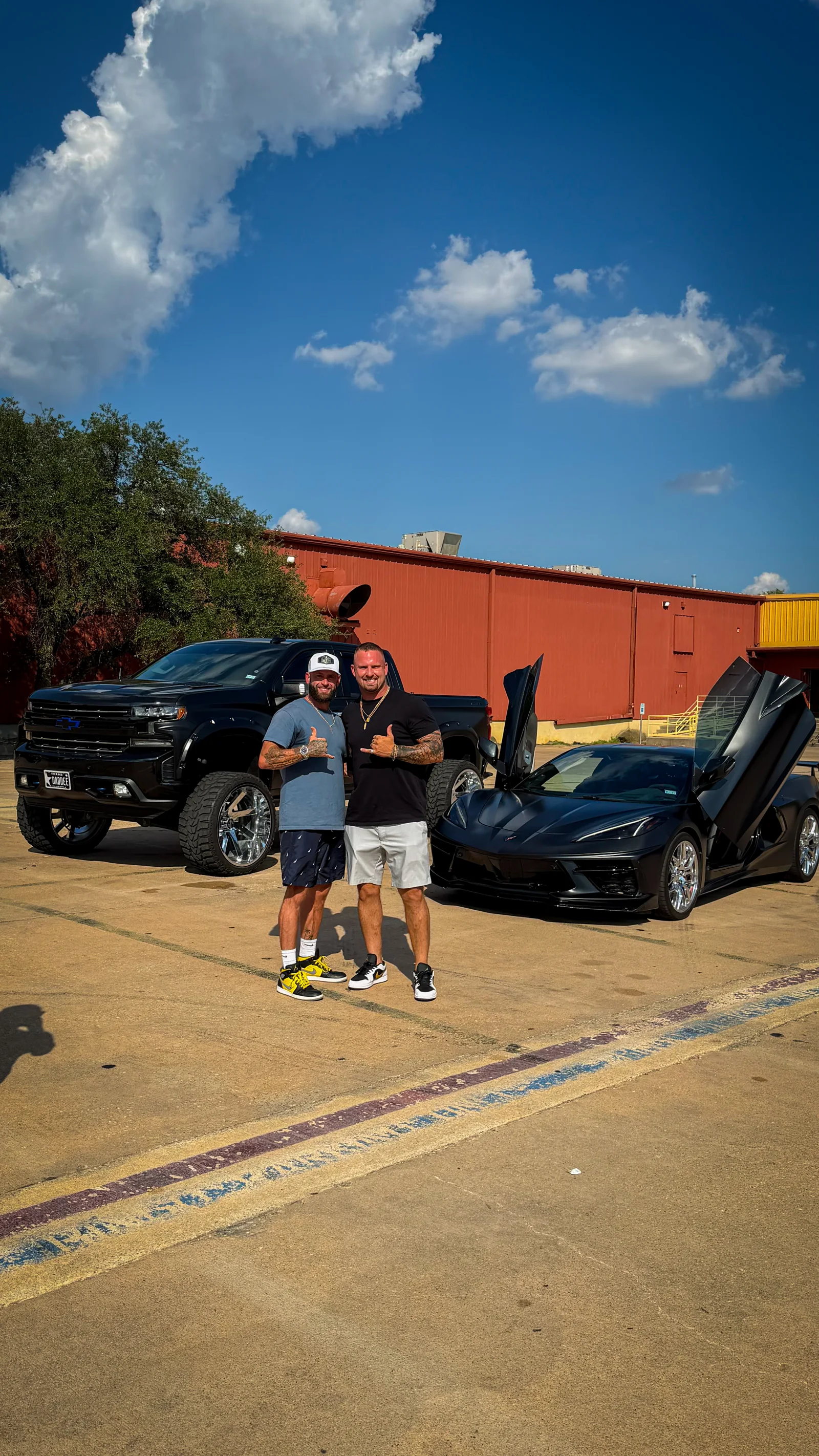 Trey and Colby Collier with their wrapped Black Widow truck and matching Corvette (C8)